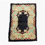 An Art Deco rug, circa 1930, possibly Balkan area, the charcoal ground with a pale blue palmette and