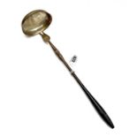 An unusal provincial or colonial punch ladle, with turned wooden handle and large oval bowl.