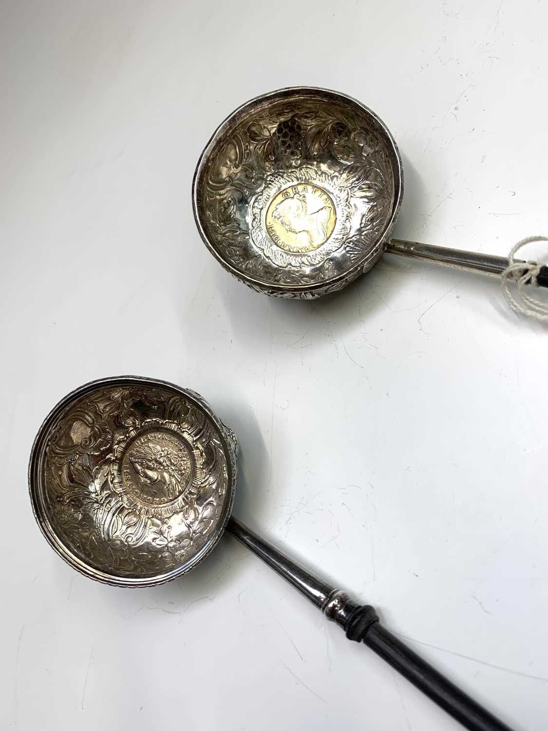 Two silver punch ladles with whale bone handles, both of round form, coin set with ornate chasing. - Bild 2 aus 4