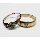 An 18ct gold ring with a daisy diamond cluster Size O 2.1gm and an 18ct gipsy set diamond ring