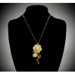A Jardin yellow mother-of-pearl flower pendant set with South Sea pearls, diopside and garnets.