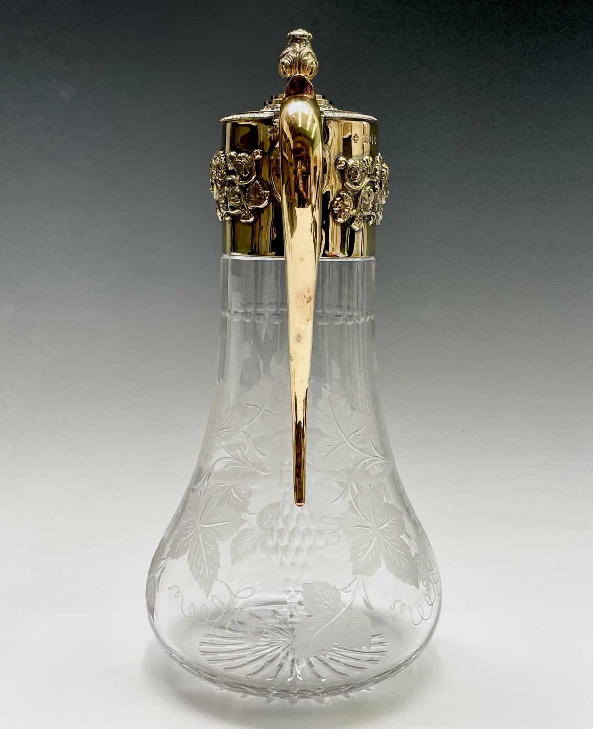 An Asprey claret jug the glass body cut and engraved with vines the silver-gilt mount with - Image 2 of 16