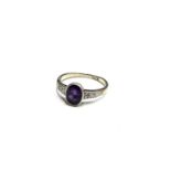 An 18ct white gold ring set an amethyst with diamond shoulders Size H/I 2.3gm