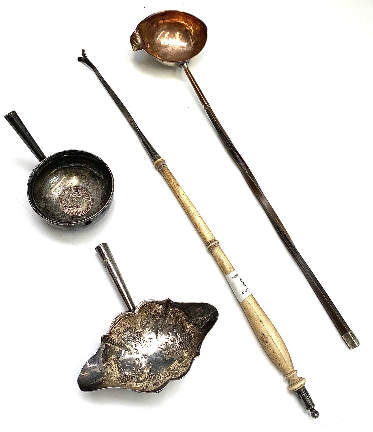 A turned ivory punch ladle handle, lacking bowl, together with two silver punch ladle bowls, one