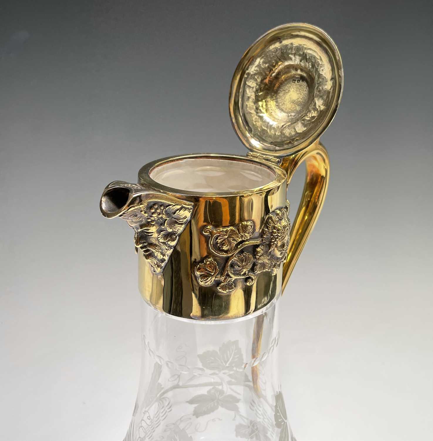 An Asprey claret jug the glass body cut and engraved with vines the silver-gilt mount with - Image 12 of 16