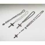 A rosary with carved amethyst beads and amethyst set silver cross, two chased silver crosses each