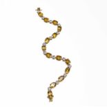 A 10ct gold bracelet with diamond centered flower-heads separating the faceted citrine. 20cm 10.1gm