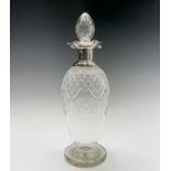 A good cut glass ovoid footed decanter with plain silver shoulder neck and quatrefoil rim by James