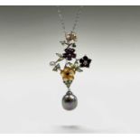 A Jardin flower pendant with pearl, peridot and garnet and with carved yellow mother of pearl