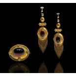 A good Victorian revivalist gold brooch and matching earrings set with carbuncles, the largest