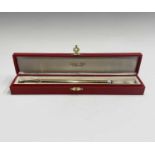A Cartier gold plated pen, one end with a red enamel band the other blue, each end takes a screw-