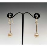 A pair gold pearl and diamond earrings. The pearl 8.66mm 3.3gm