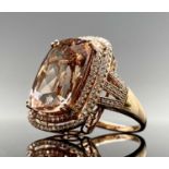 A desirable morganite ring with a rectangular cushion cut stone of 13.75ct in a 18ct rose gold