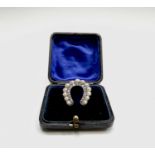 A Victorian diamond and pearl horseshoe brooch height 27mm 6gm