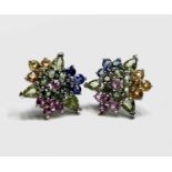 A pair of multi-coloured sapphire earrings set with yellow, blue, pink and green stones in 9ct white