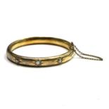 A Victorian high-purity matt gold hinged bangle with three gypsy set diamonds Internal size