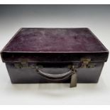 A purple leather toilet case by Mappin and Webb, the purple silk interior with silver-mounted