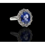 A dazzling Ceylon 5.5ct oval sapphire, set in a .950 platinum ring with diamonds totalling 1.25cts