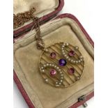 A 9ct gold Belle Epoch disc grille pendant set with pearls red stones and an amethyst on 40cm