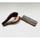 A gold-mounted cigarette holder, cased and a silver-mounted horses hoof meerschaum cheroot holder