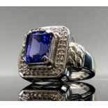 An 18ct white gold ring set an AAAA tanzanite of 4.25cts within diamonds. Size N 12.5gm