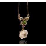 A butterfly and flowerhead pendant set with peridot and ruby