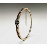 A 9ct gold diamond and sapphire bangle 50x58mm 11.4gm Birmingham 1988Condition report: Good used