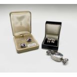 A silver "Toffee" pillbox the lid set with an amethyst, a pair of silver and amethyst cufflinks