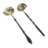 Two Georgian silver punch ladles, with fluted bowls One with a turned wooden handle the other part