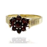 An 18ct red stone cluster ring 5.4gm Size U