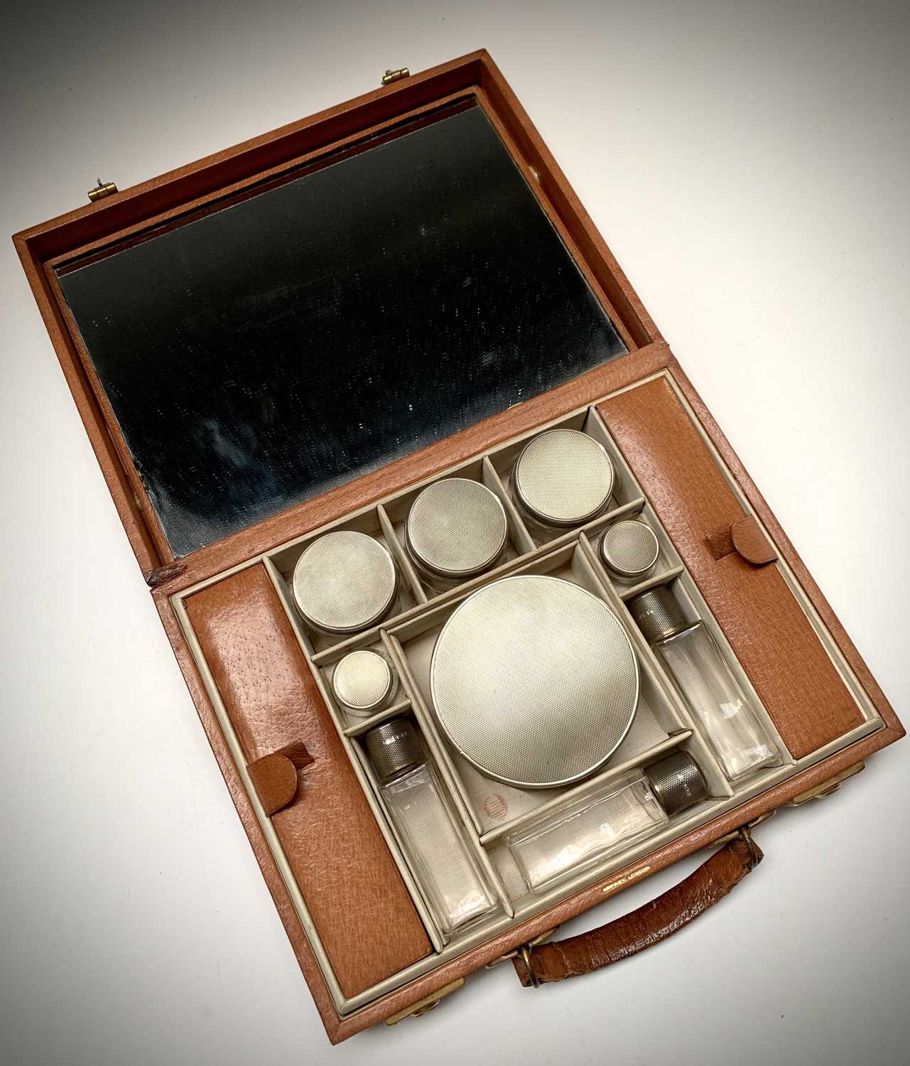 Asprey London ostrich leather gentleman's vanity case, with nine engine-turned silver-mounted