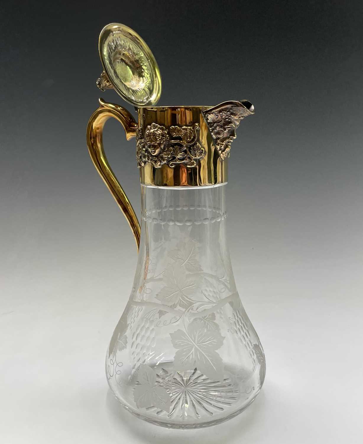 An Asprey claret jug the glass body cut and engraved with vines the silver-gilt mount with - Image 7 of 16