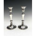 An Edwardian pair of William Comyns filled silver crested candlesticks with detachable nozzles