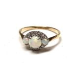 An 18ct gold and platinum navette ring set with three opals and diamonds. Size Q/R 2.8gmCondition