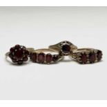 Four gold rings set with garnets Sizes range from S to V 13.4gm