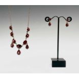 A 9ct gold red stone set necklace and a pair of gold red stone set earrings 12.5gm