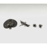 A silver and marcasite peacock brooch, a dragonfly brooch and a pair of earrings.Condition report: