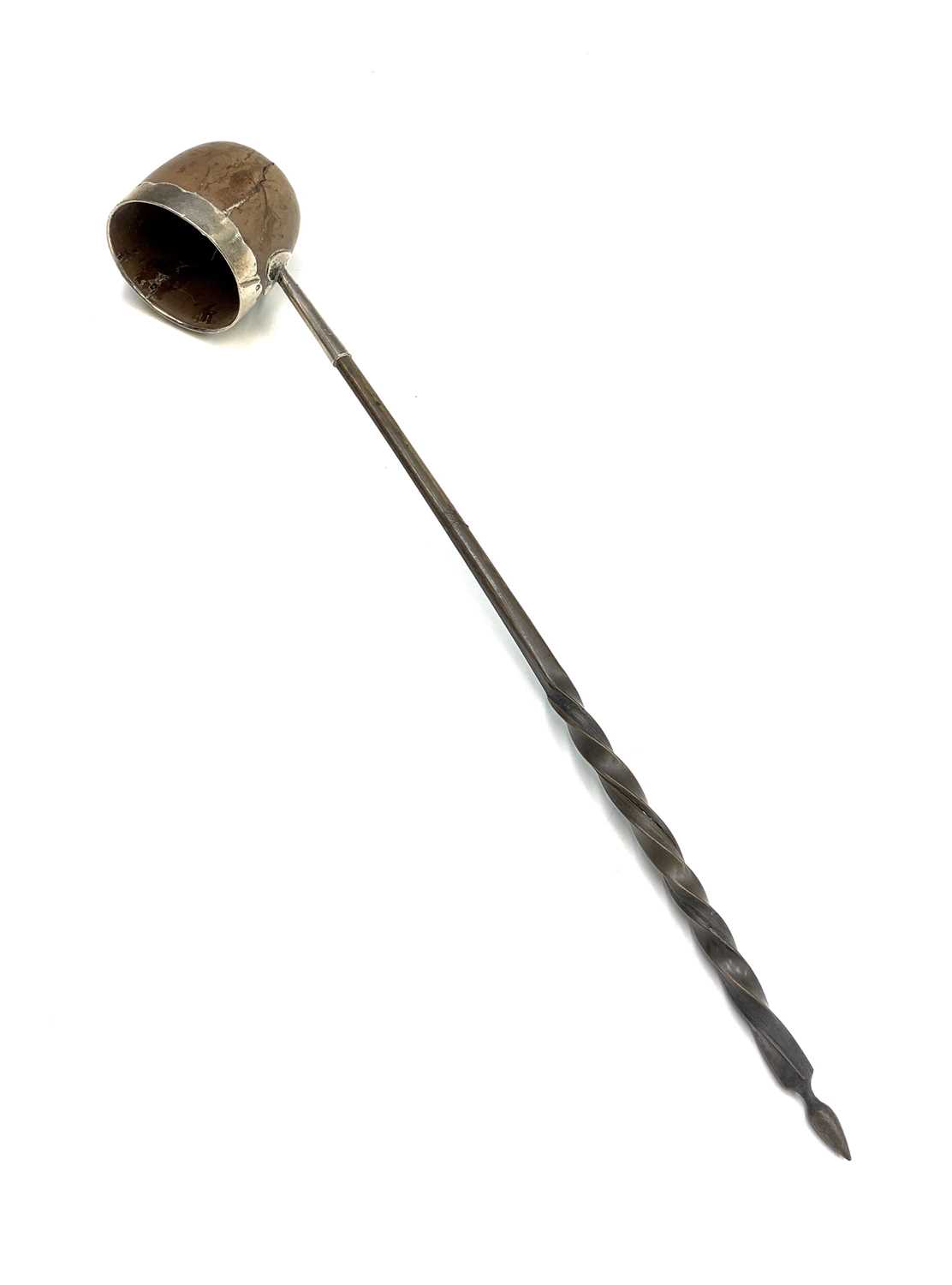 A Georgian punch ladle with spiral whale bone handle, the bowl a silver mounted wooden nut.