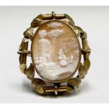 A Victorian cameo brooch with ornate gilt chased mount. The cameo 38.4x30mm