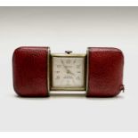 A Hermes 15 jewel purse timepiece in gold plated with sliding red leather case 53.2x35.6mm when