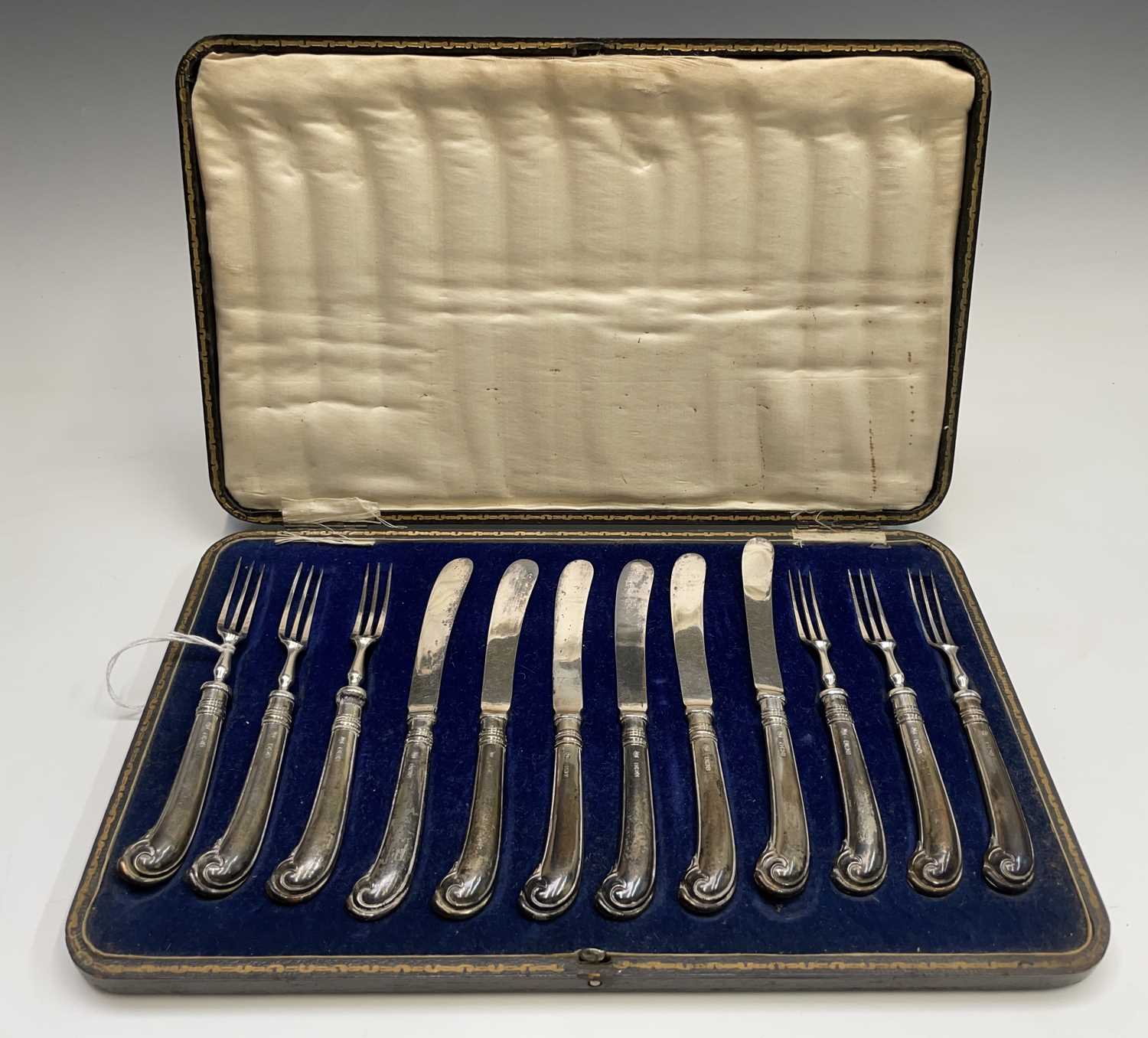 A set of six dessert knives and forks with the filled pistol grip handles marked for John