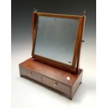 A George III mahogany and boxwood strung dressing table mirror, the base fitted with two drawers,