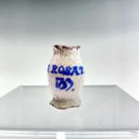 A small Delft tin glazed ointment pot inscribed 'O.Rosat.1733'. Height 3.5cm.