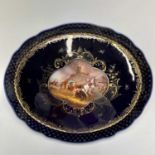 A Dresden porcelain oval small tray, circa 1900, centrally painted with a skirmish within a cobalt