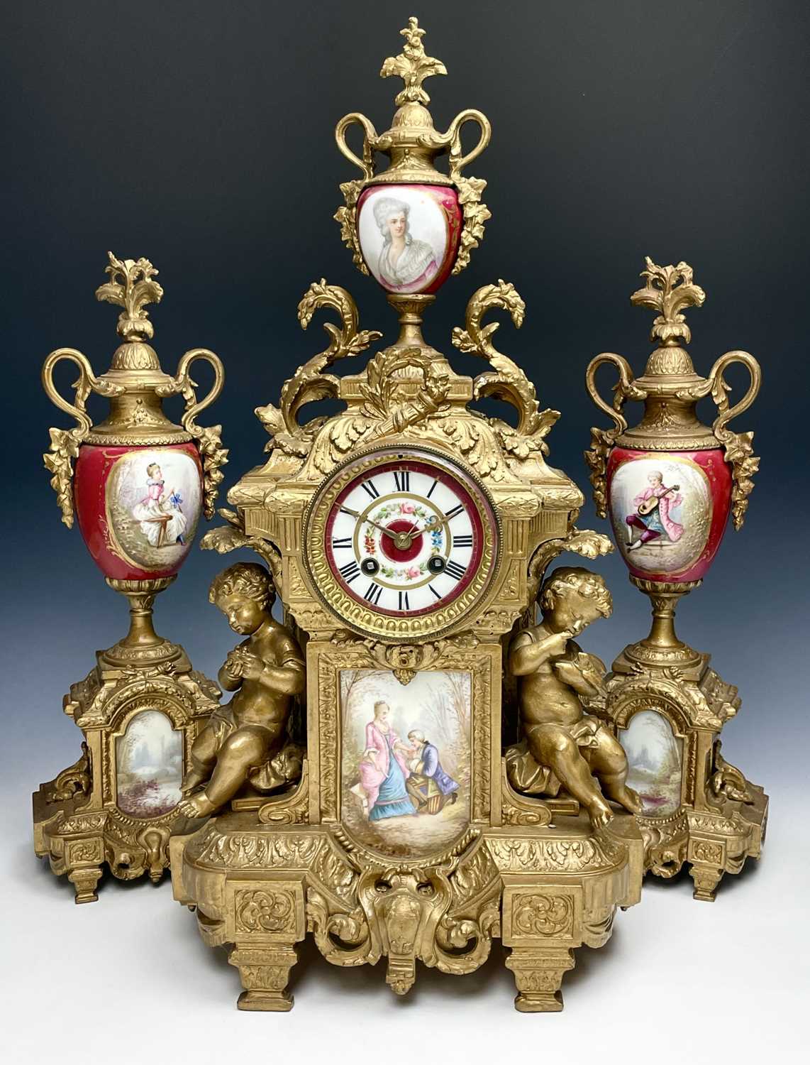 A 19th century gilt metal and porcelain three piece clock garniture, height of clock 56cm, width
