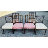 A pair of Regency mahogany dining chairs with carved X backs, stuffover seats on turned front