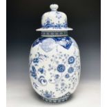 A late 19th century continental blue and white transfer printed lidded urn shape vase. Height 45cm.