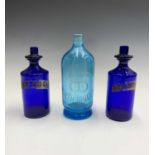 An early 20th century blue glass chemist's bottle, bearing etched inscription 'Williamson & Hogg