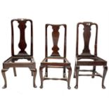 A Queen Anne walnut dining chair raised on cabriole legs, with pointed pad feet, and two other