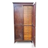 A George III mahogany two part collectors cabinet, with moulded cornice above four panel doors